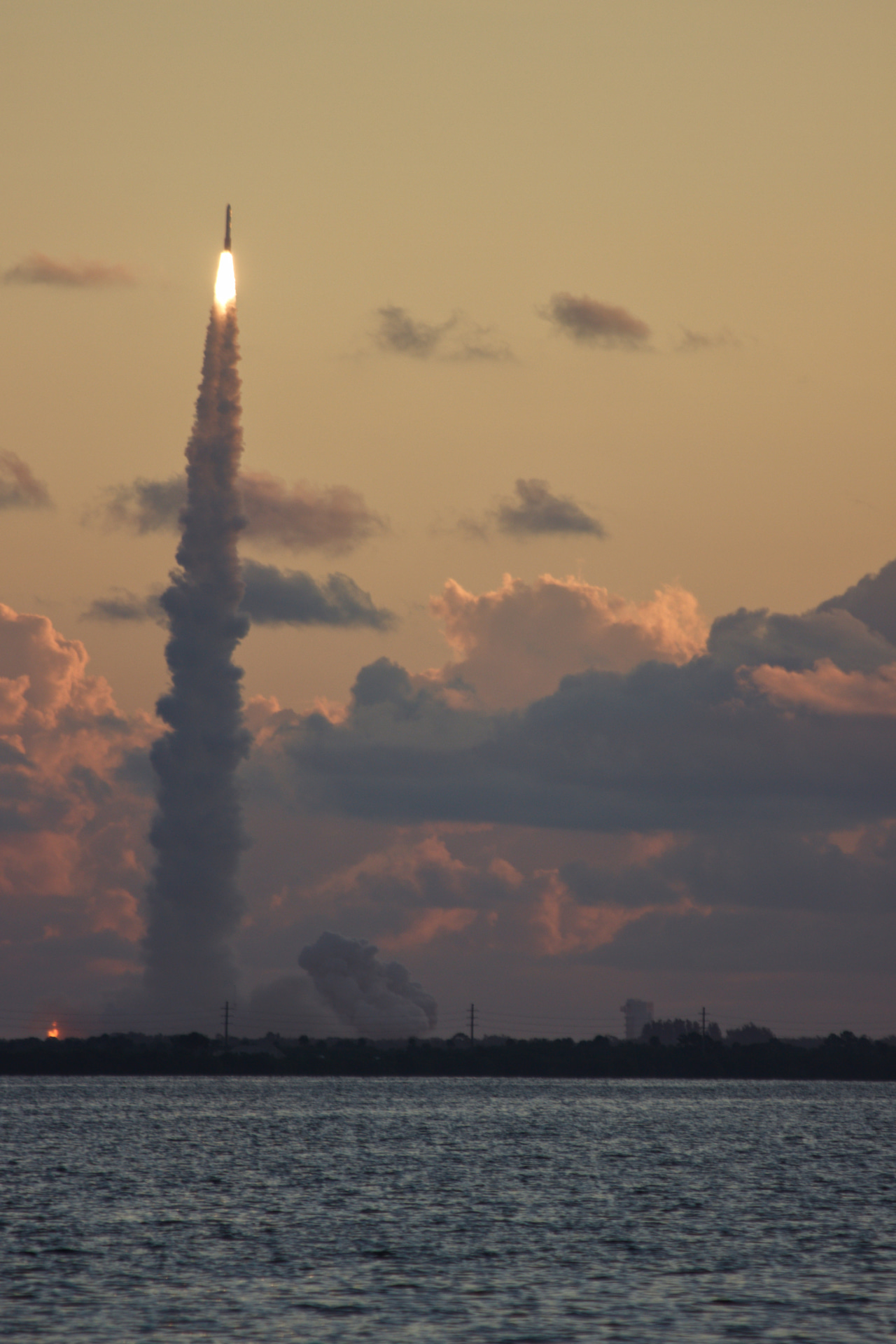 an amber and gold morning, steeped in indigo and lavender clouds, as Vulcan launches on a column of smoke